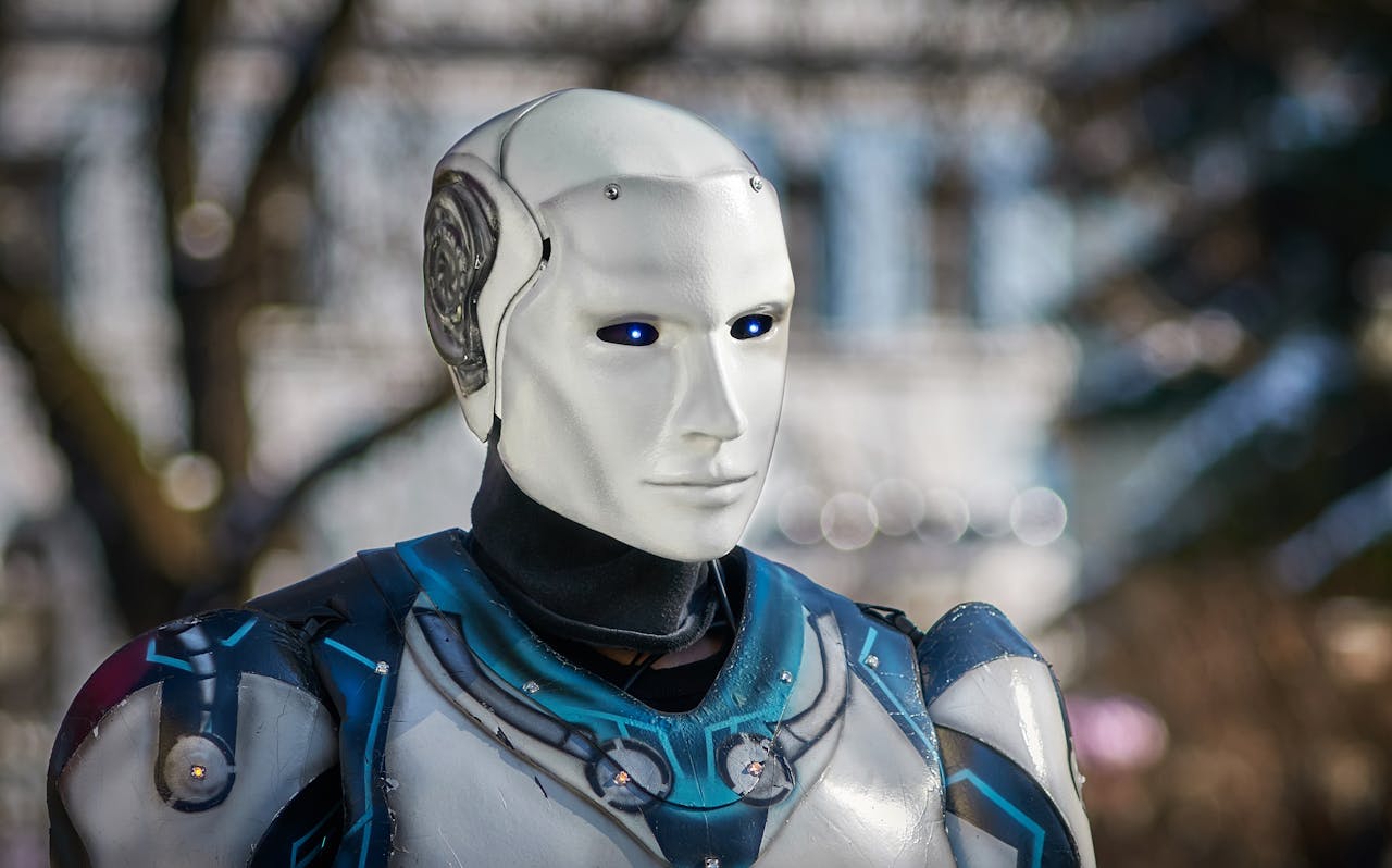 Close-up of a futuristic humanoid robot with metallic armor and blue LED eyes.